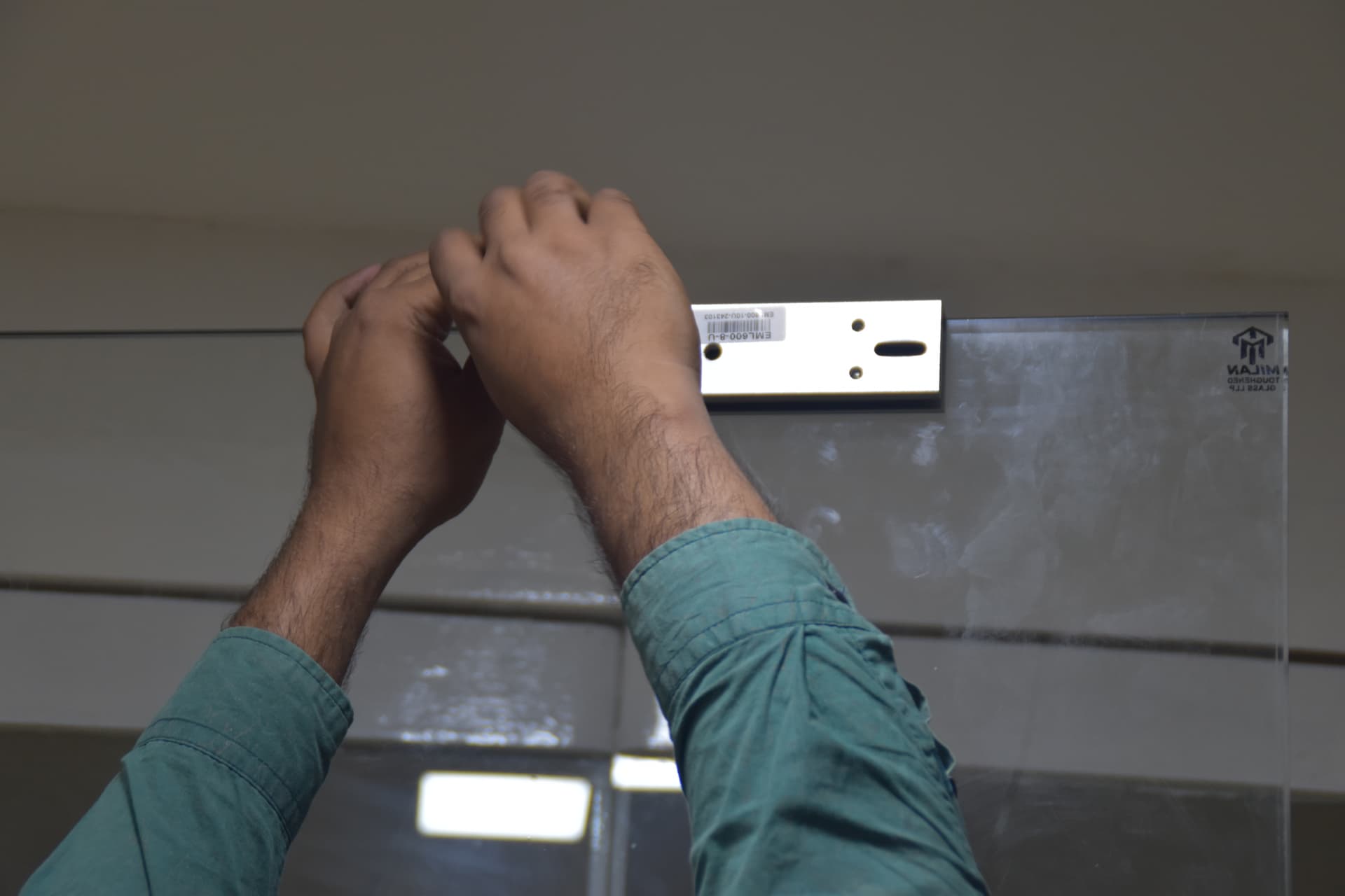 Layerix engineer fitting electromagnetic EM door lock for biometric access control system — Ramanashree Hotels, Bengaluru