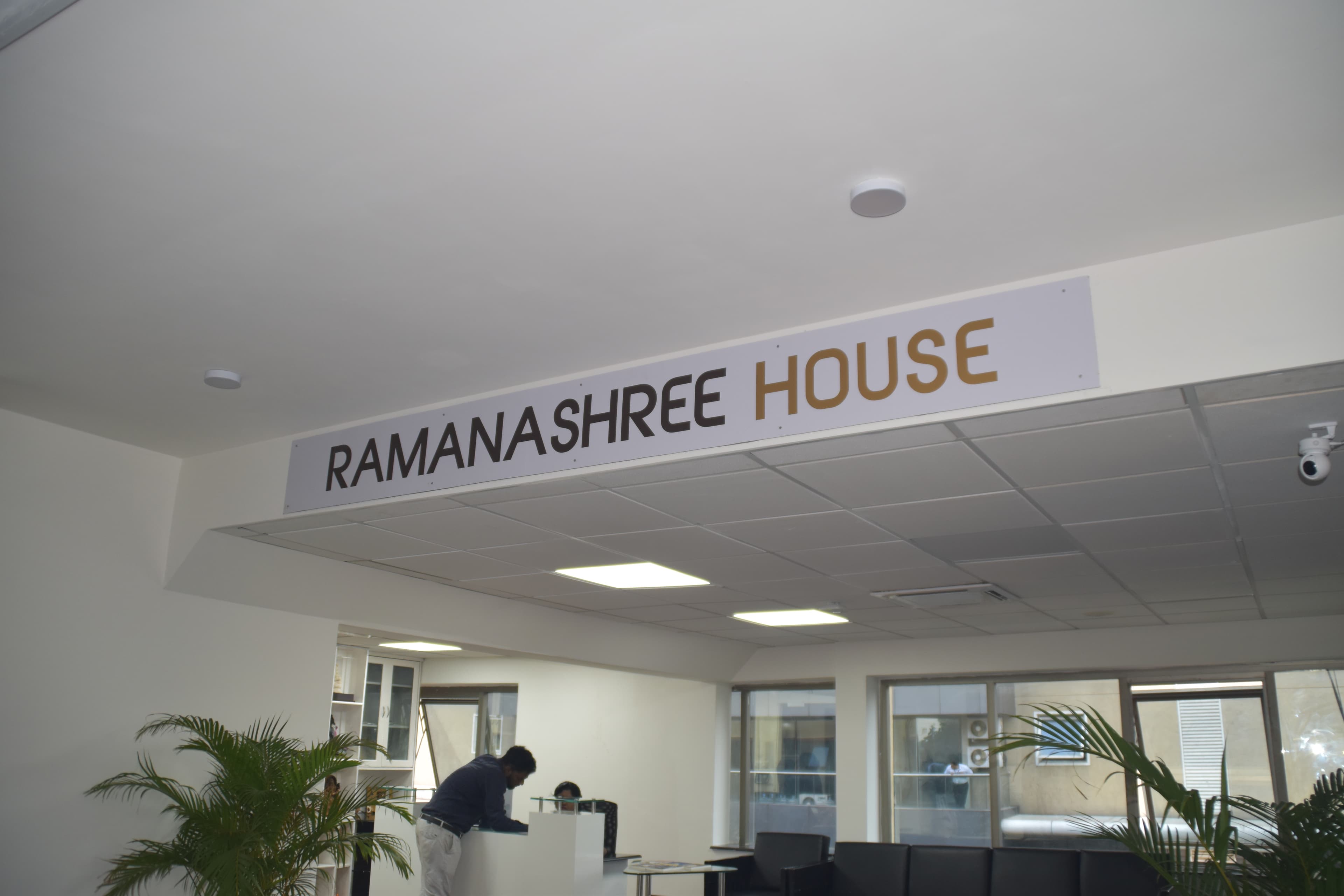Ramanashree House — head office reception lobby with Aruba WiFi 6 ceiling-mount access point and IP CCTV camera installed by Layerix Networking Experts, Bengaluru